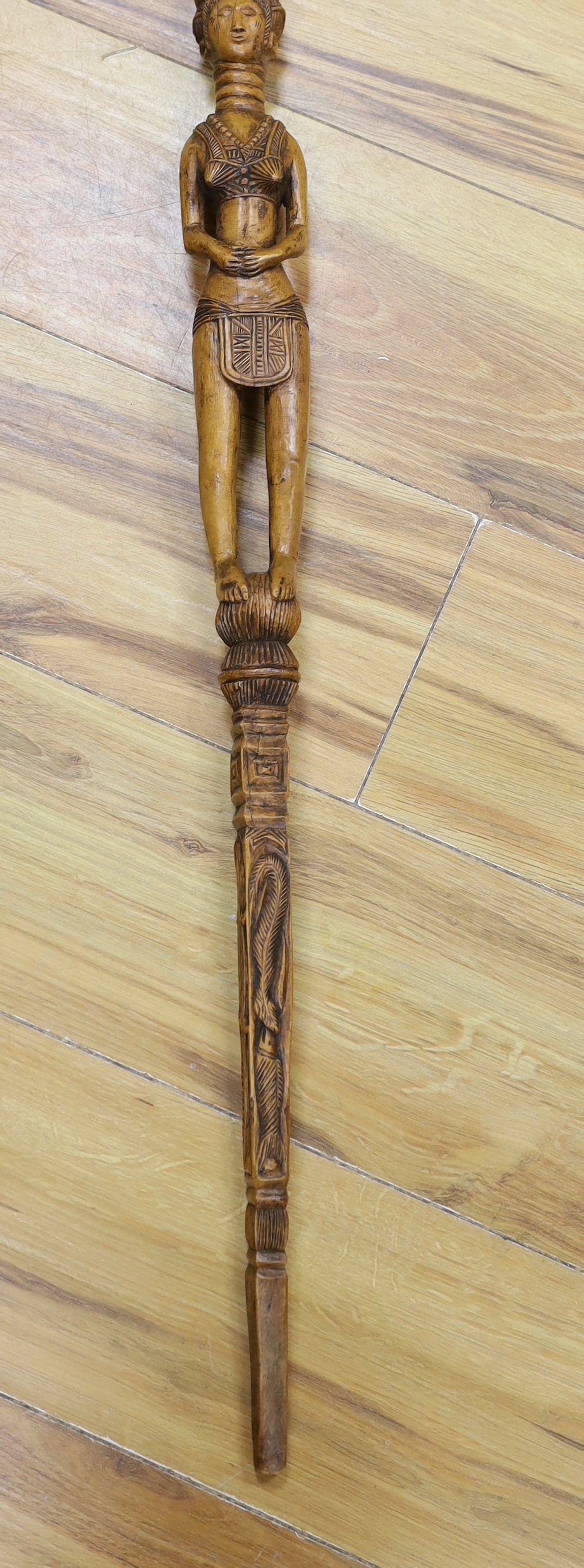 An African framed tribal mask and a carved stick